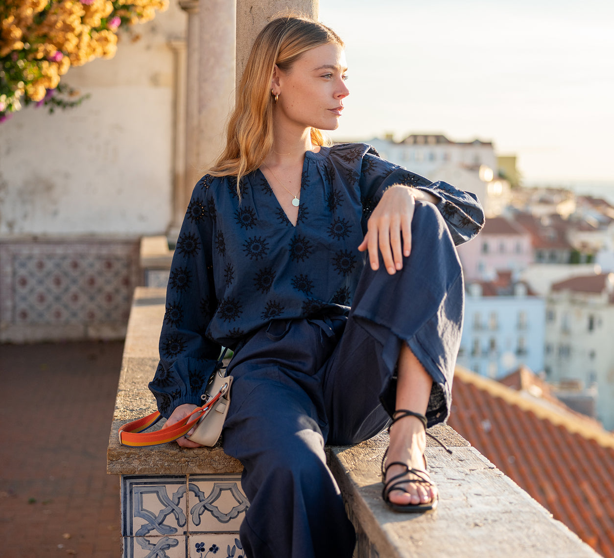 Image of a woman wearing a blue long sleeve eyelet top and matching pants