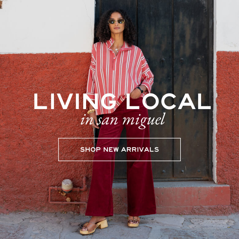 Woman in red and white striped shirt and red pants standing against a red wall with text overlay.