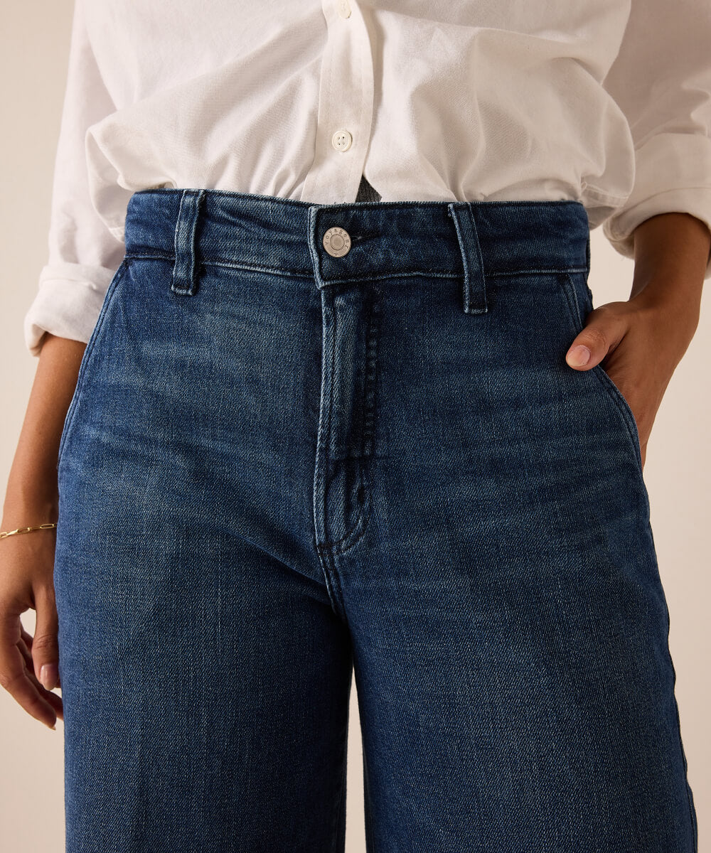 Ladies' travel-ready dark indigo denim jeans with a high-rise waist and button closure.