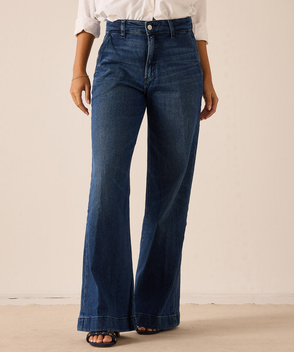 Medium wash blue high-waisted flared wide-leg denim jeans.
