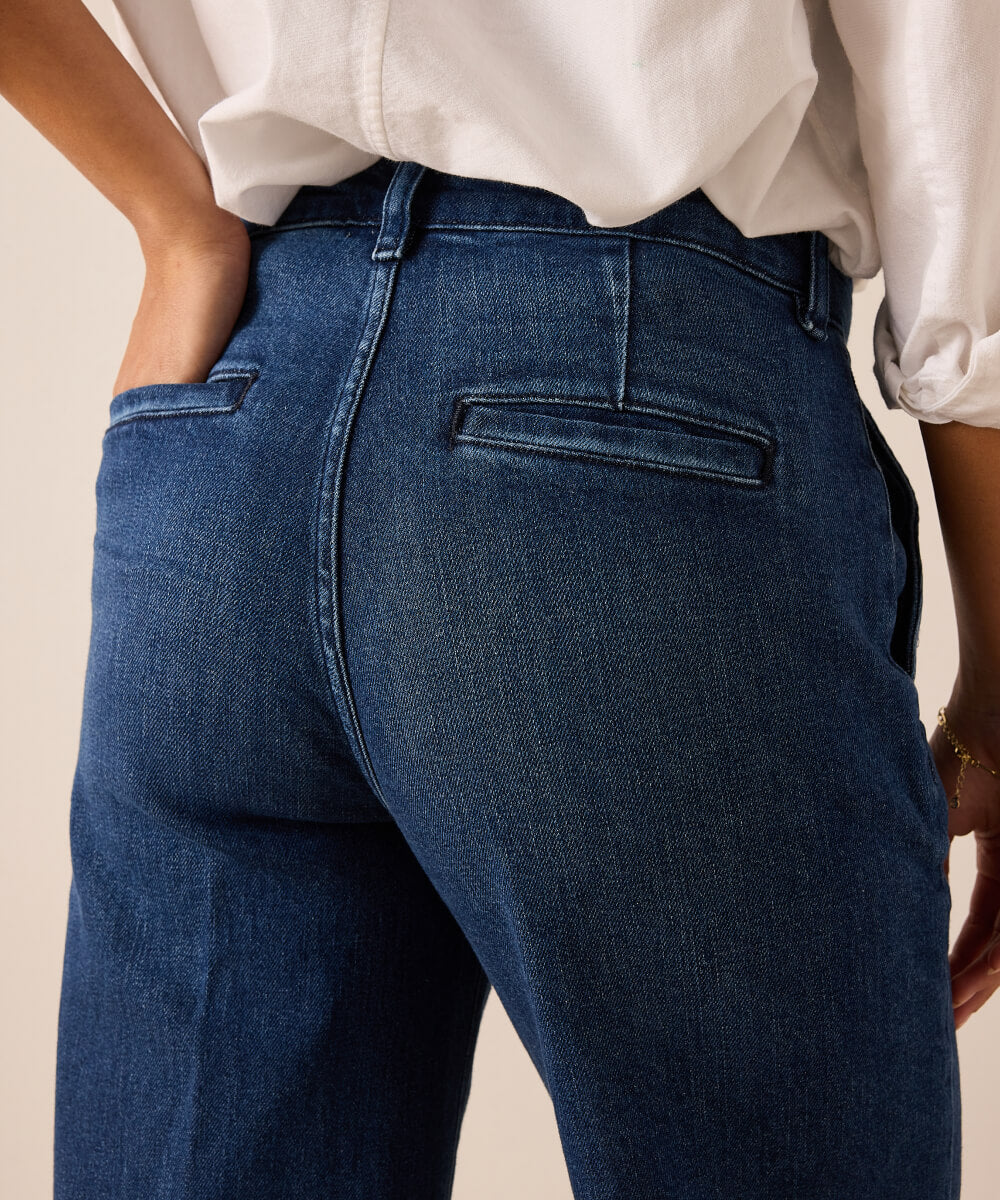 Deep indigo denim wide-leg trousers with a unique horizontal back pocket and reinforced stitching details