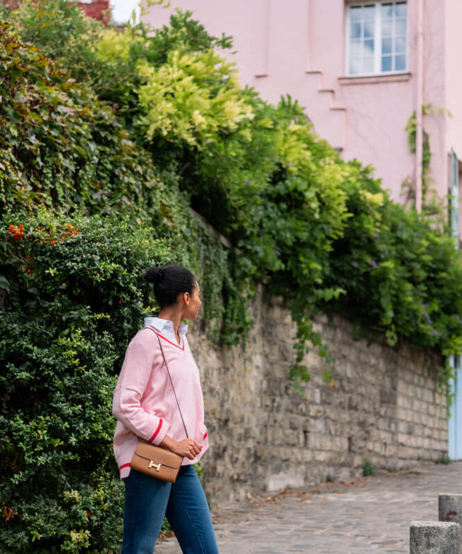 Image of a woman wearing a pink v-neck sweater.