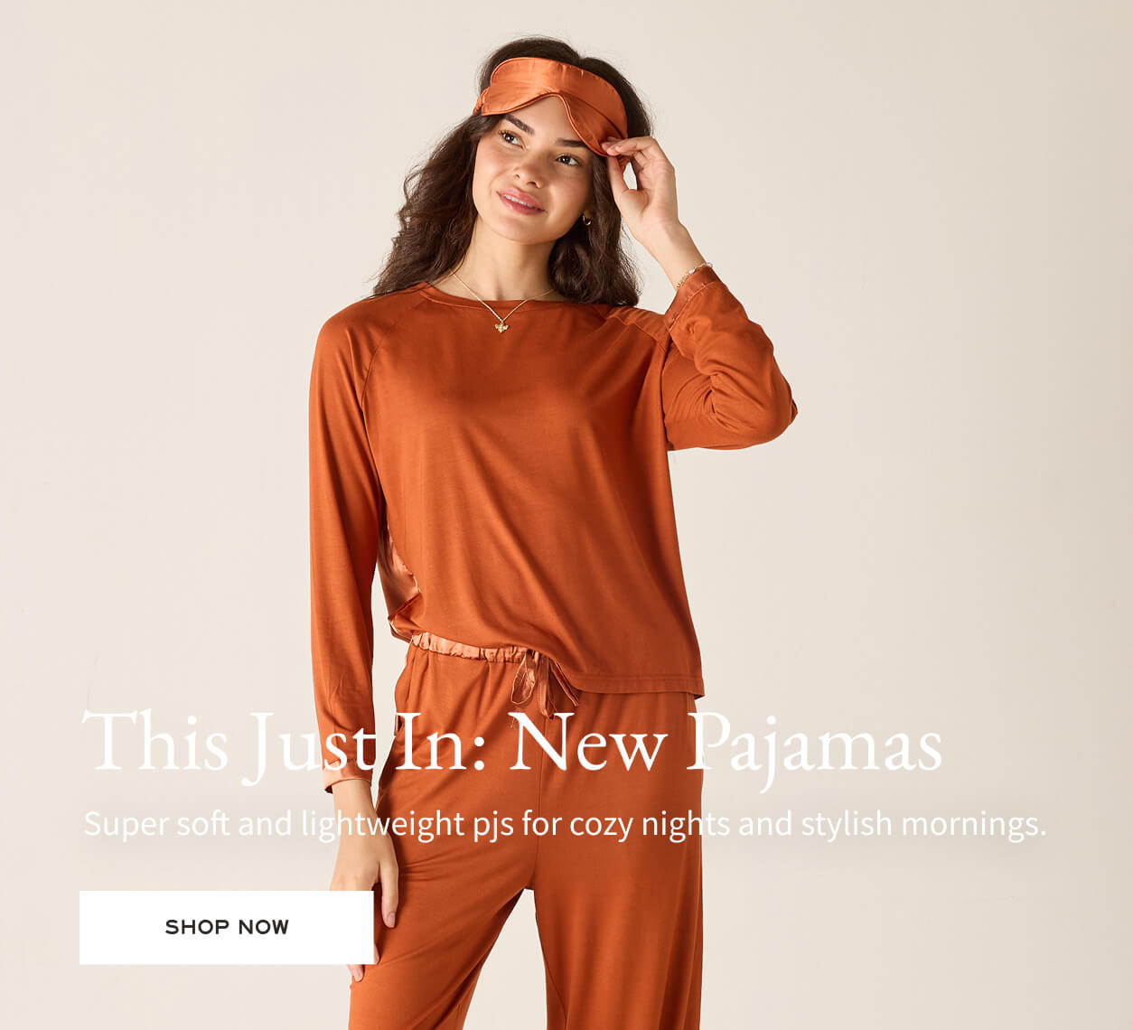 This Just In: New Pajamas  - Super soft and lightweight pjs for cozy nights and stylish mornings. - Image of a woman wearing a burnt orange modal pj set with matching eye mask 