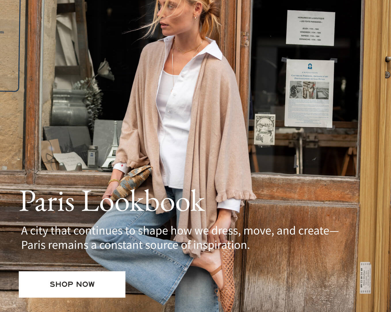 Woman standing in front of a store window with text about Paris Lookbook.