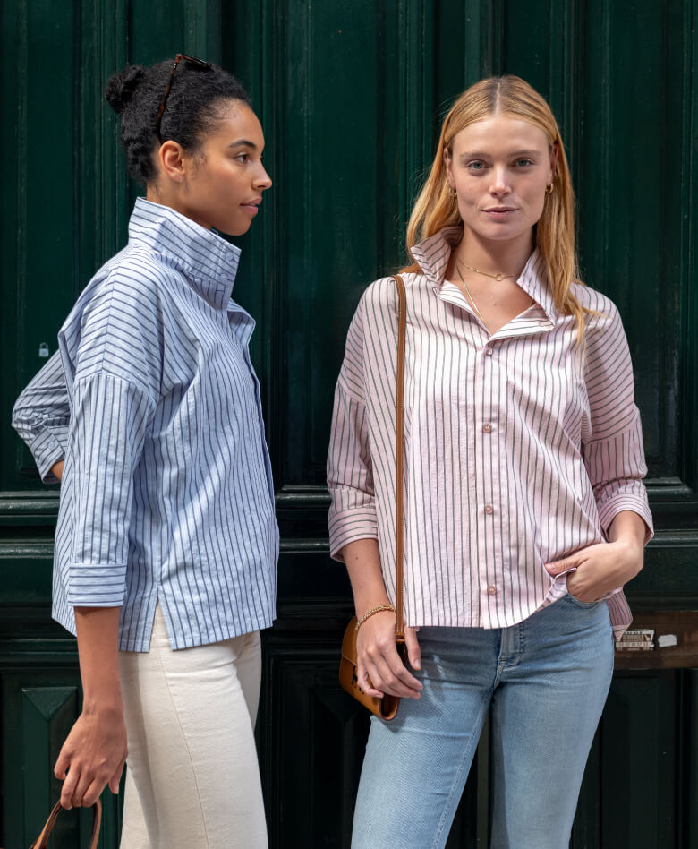 Image of two women wearing striped shirts with pop-up collars