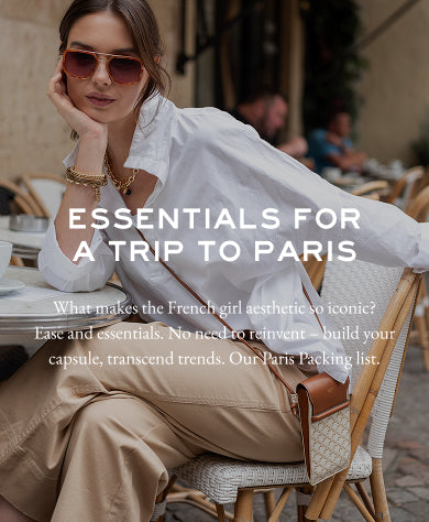 Woman sitting at a table in Paris with text overlay about essentials for a trip to Paris.