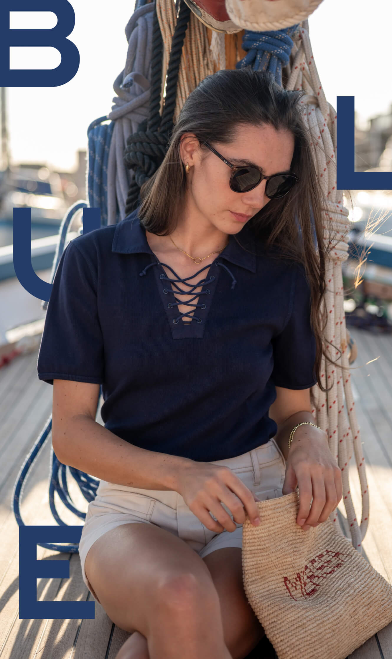 Image of a woman wearing a blue lace-up top.