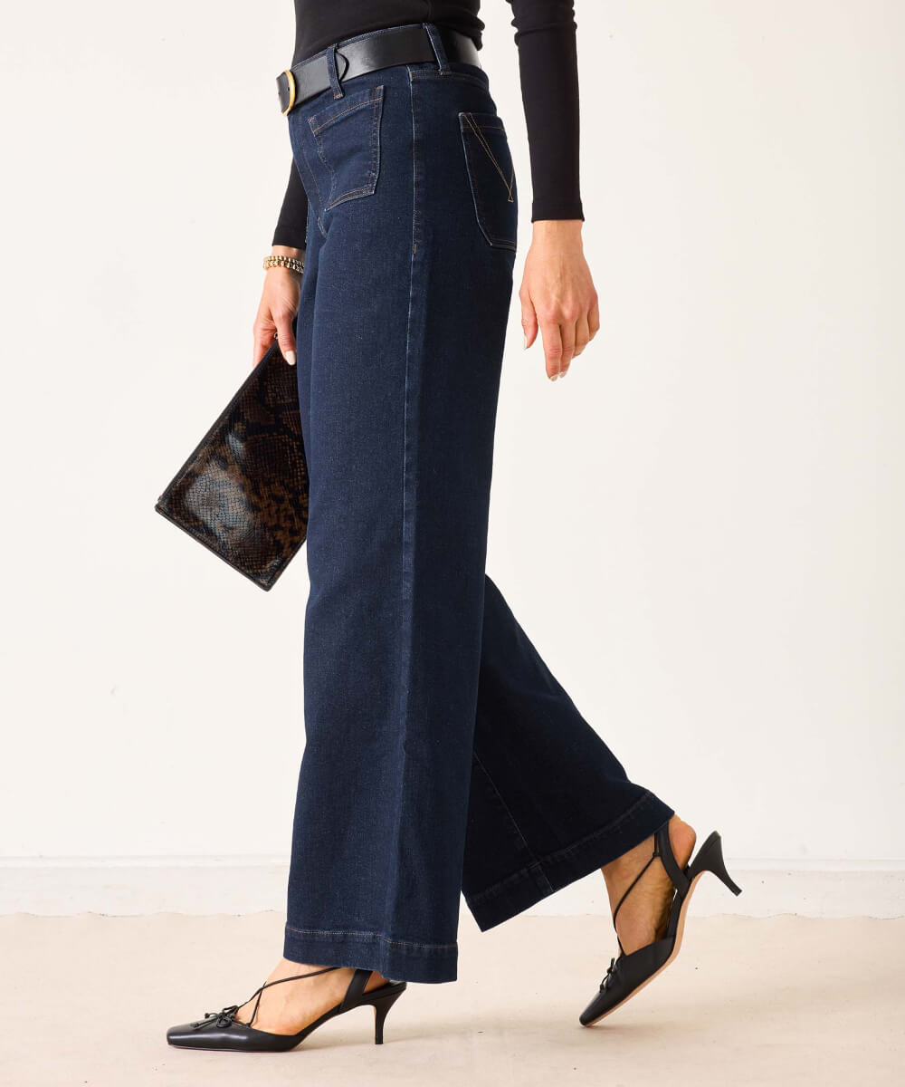 Dark wash denim wide-leg trousers with a front crease and belt loop.