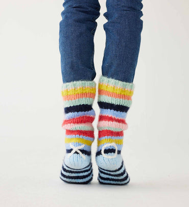 female wearing multi striped slipper socks with white XO on ankles on a white background