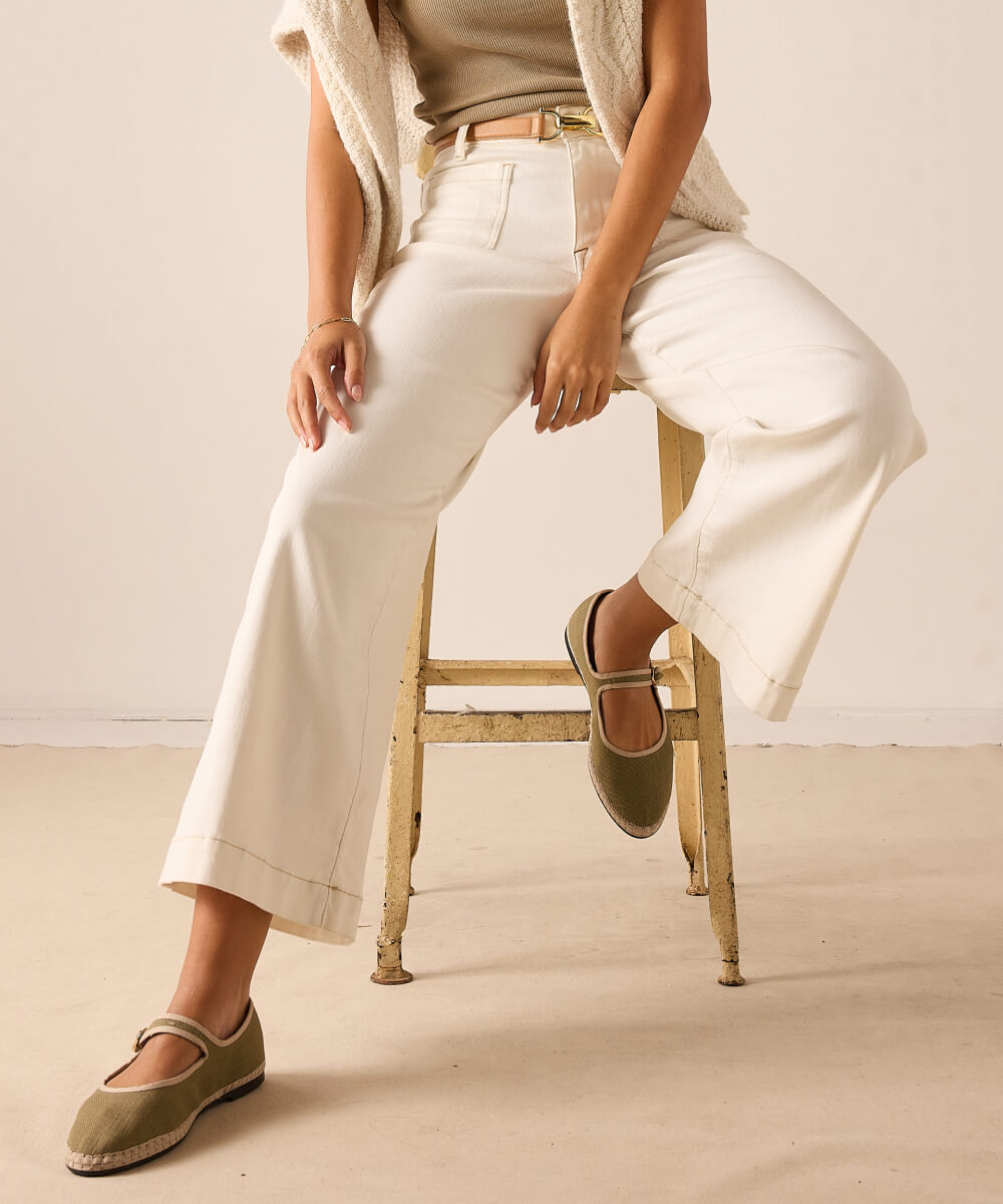 Ivory white wide-leg cropped pants in a woven fabric with front pockets.