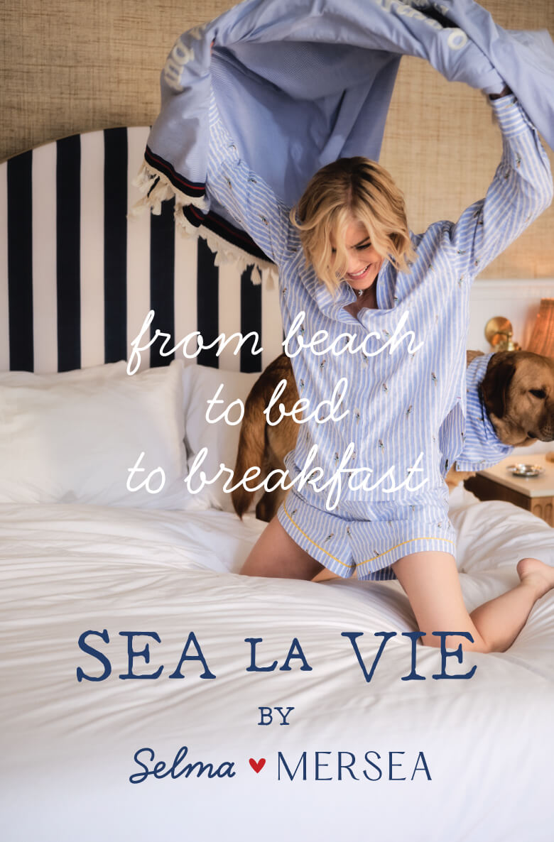 Woman in a striped robe on a bed with text 'from beach to bed to breakfast' and 'Sea La Vie by Selma Mersea'.