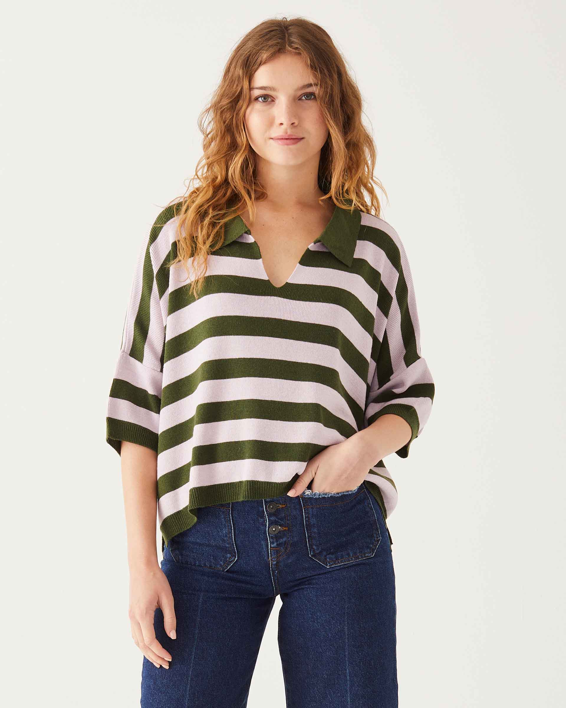 female wearing green and purple striped polo sweater with a collar and v neck on a white background