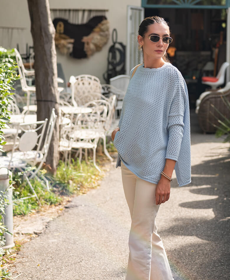 Image of a woman wearing a light blue sweater.