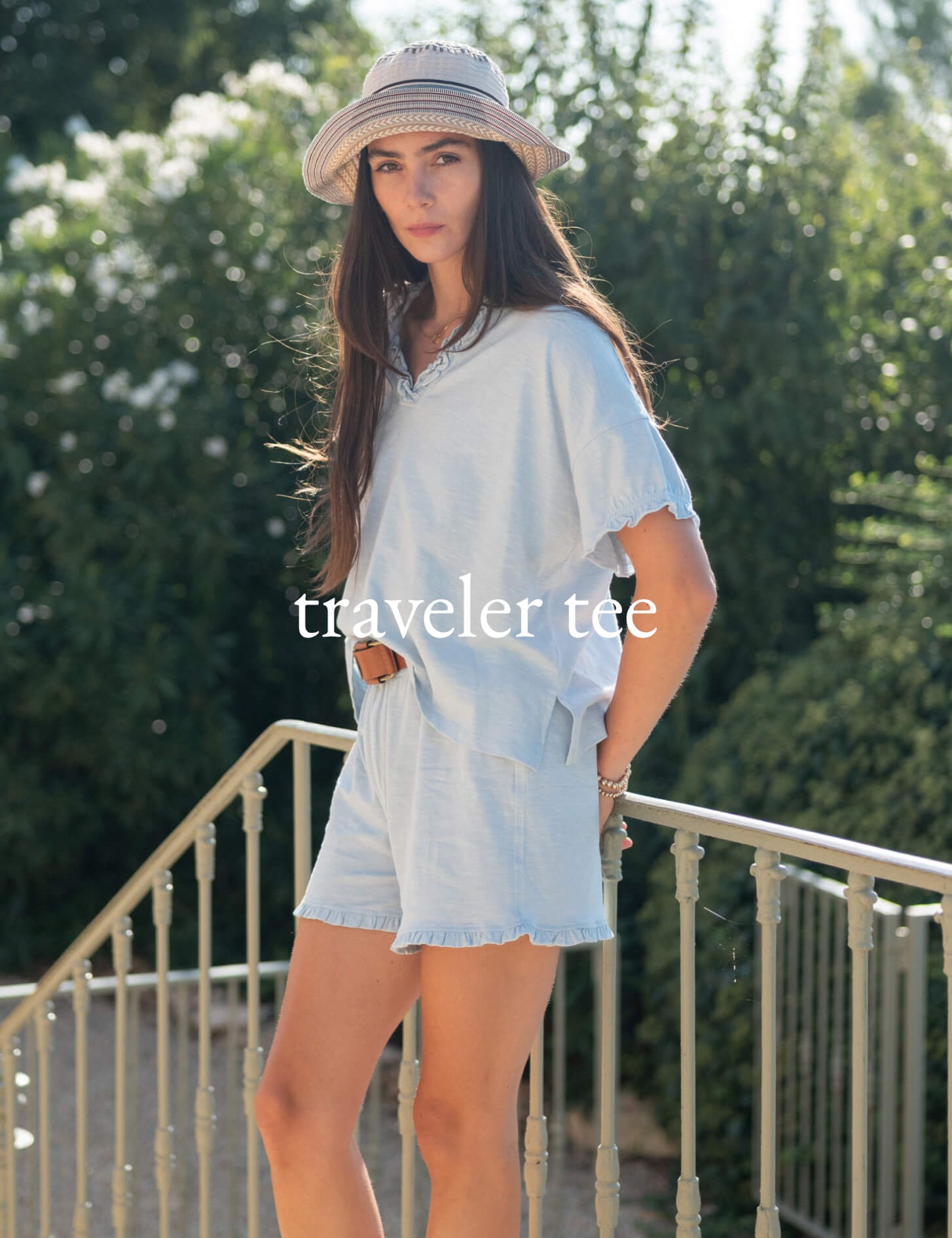 Traveler Tee - Image of a woman wearing a light blue tee travel set