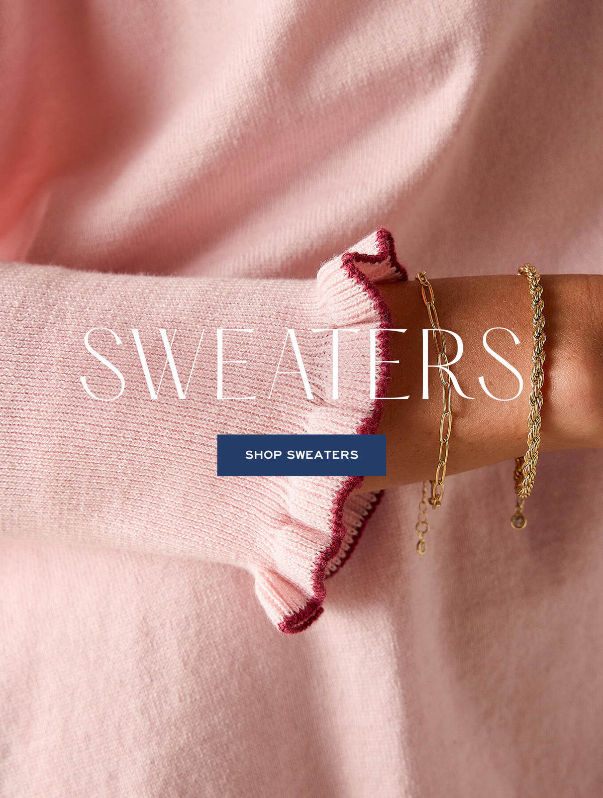 Promotional banner featuring a woman's arm in a light pink knitted sweater with a scalloped edge. Text: "SWEATERS SHOP SWEATERS"