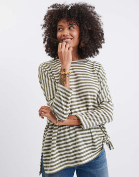 female wearing green and white striped long sleeve tee shirt on a white background 