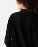 closeup rearview of woman showcasing black mersea modern oxford tee button down