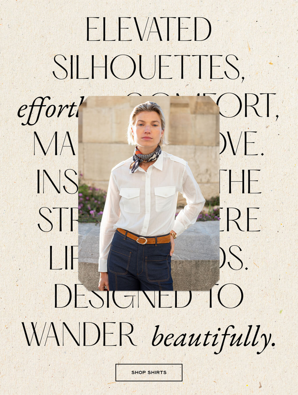 A model wearing a white linen shirt and neckerchief stands against an architectural stone background with large typography overlay. Text: "ELEVATED SILHOUETTES, EFFORTLESS COMFORT, MADE INSPIRED BY THE STEADY LIFE OF TRAVELERS. DESIGNED TO WANDER beautifully." Button text: "SHOP SHIRTS"