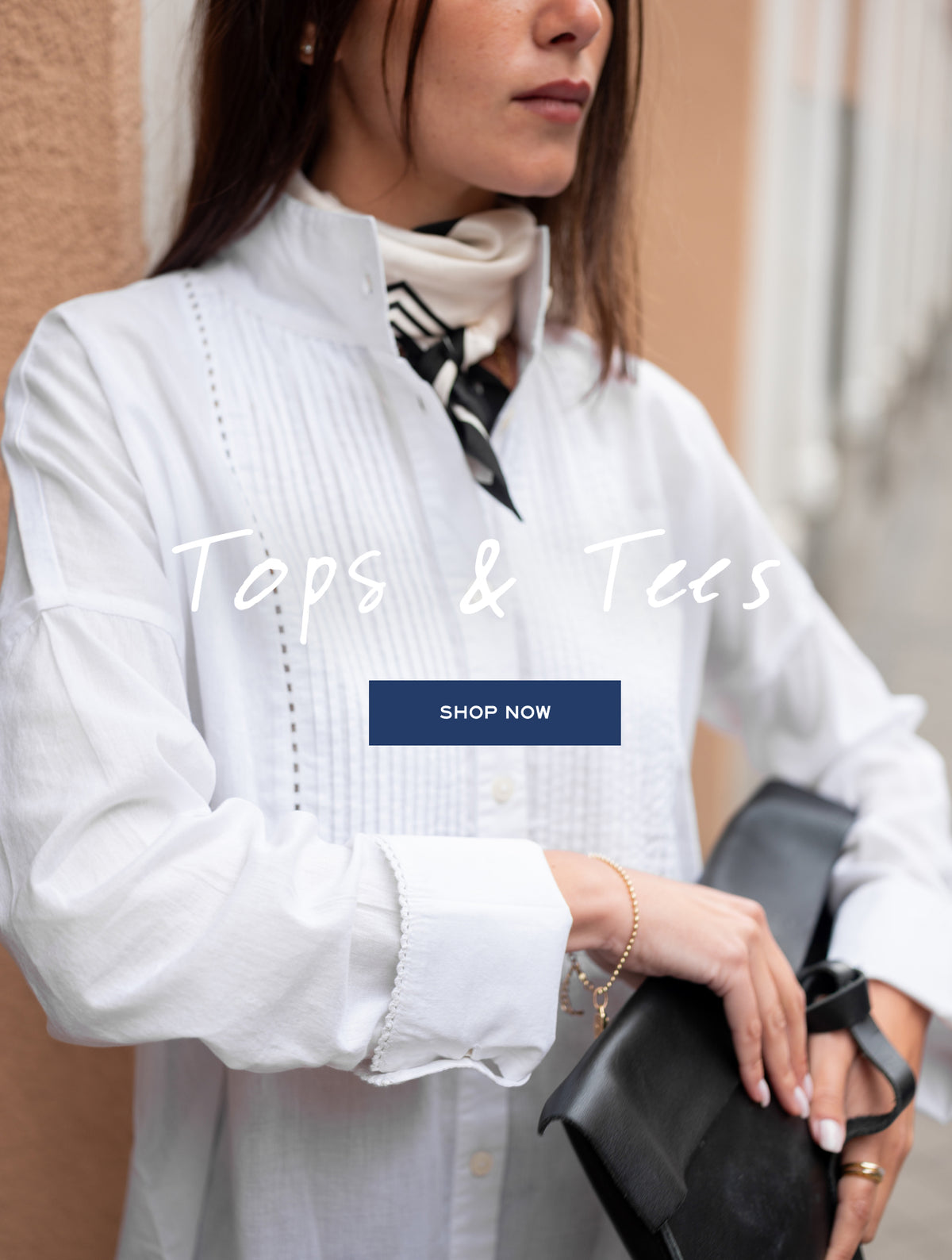 Promotional banner for tops and tees. Text: 'Tops & Tees' 'SHOP NOW'