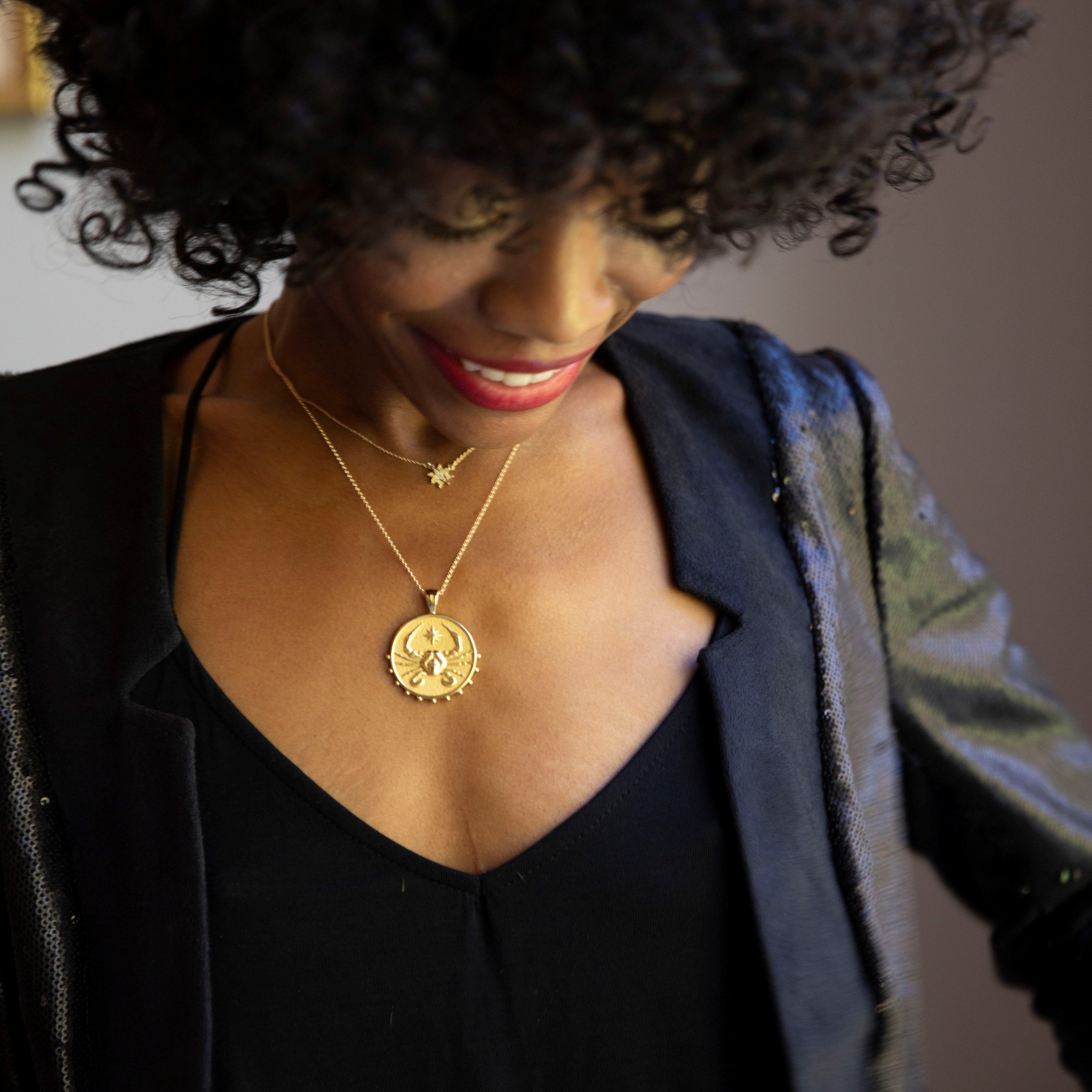 woman wearing mersea colab cancer zodiac pendant with chain