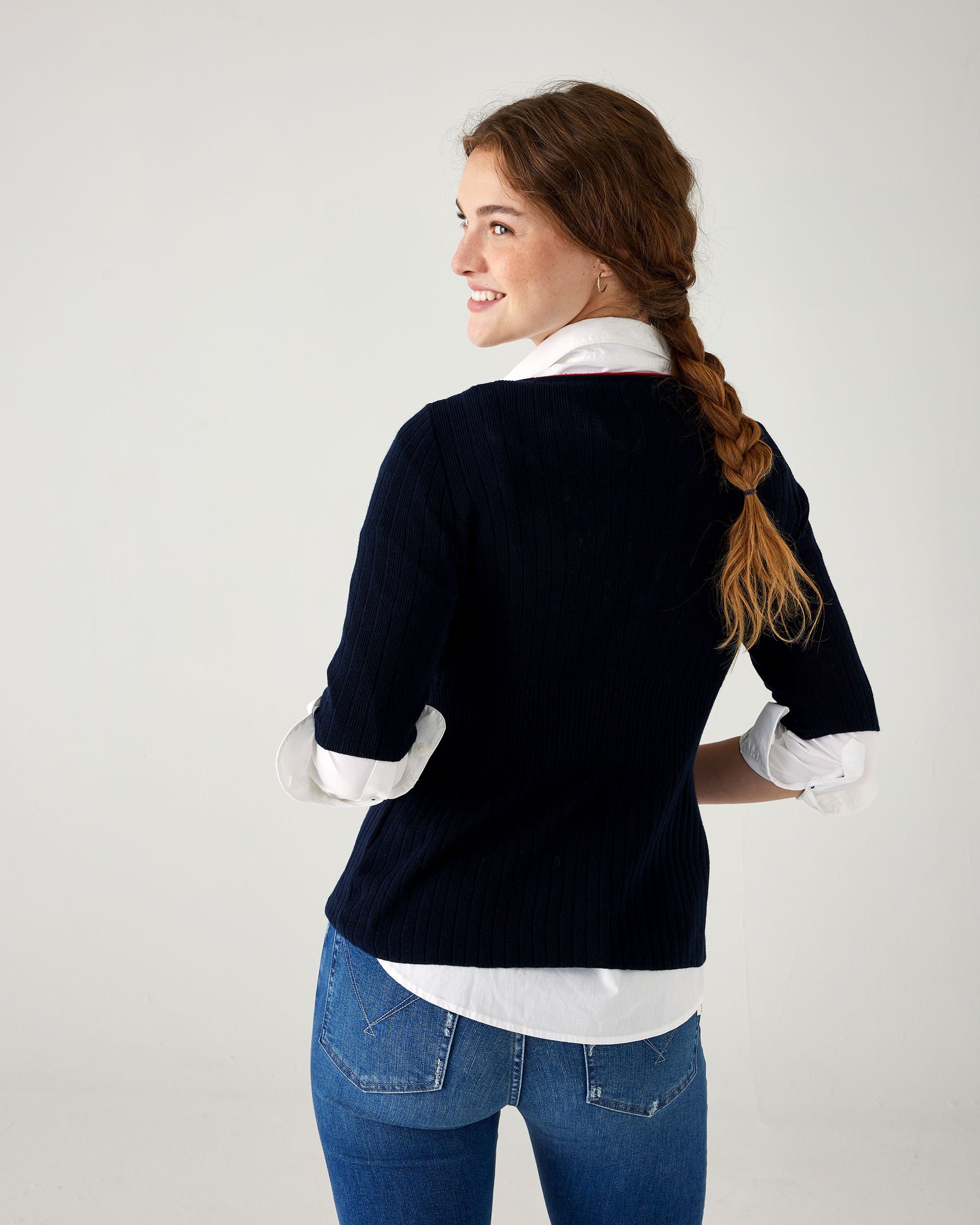 rear view of woman showcasing mersea acton rib knit navy top