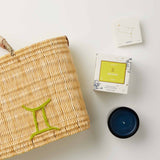 Mersea Gemini candle next to candle box and medina bag on white background