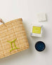 Mersea Gemini candle next to candle box and medina bag on white background
