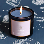 Mersea Gemini scented candle set against an astrology sign-themed backdrop