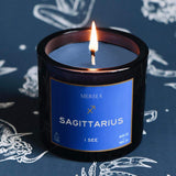 Mersea Sagittarius candle against astrology sign background