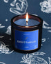 Mersea Sagittarius candle against astrology sign background