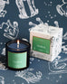 Mersea Taurus scented candle displayed beside its accompanying box, set against an astrology sign-themed backdrop