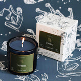 Mersea Virgo scented candle displayed beside its accompanying box, set against an astrology sign-themed backdrop