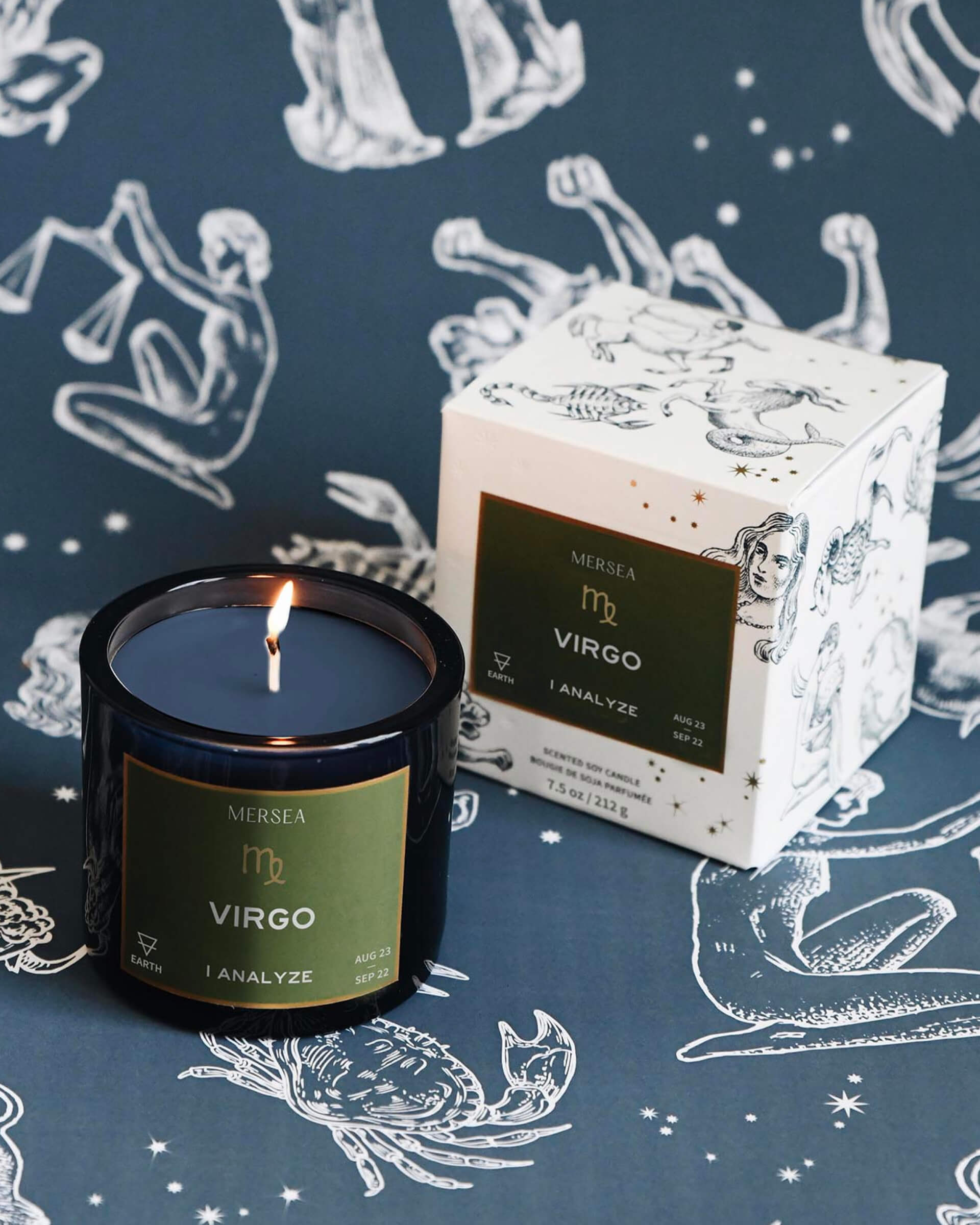 Mersea Virgo scented candle displayed beside its accompanying box, set against an astrology sign-themed backdrop