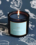 Mersea Aquarius scented candle displayed against an astrology sign-themed backdrop