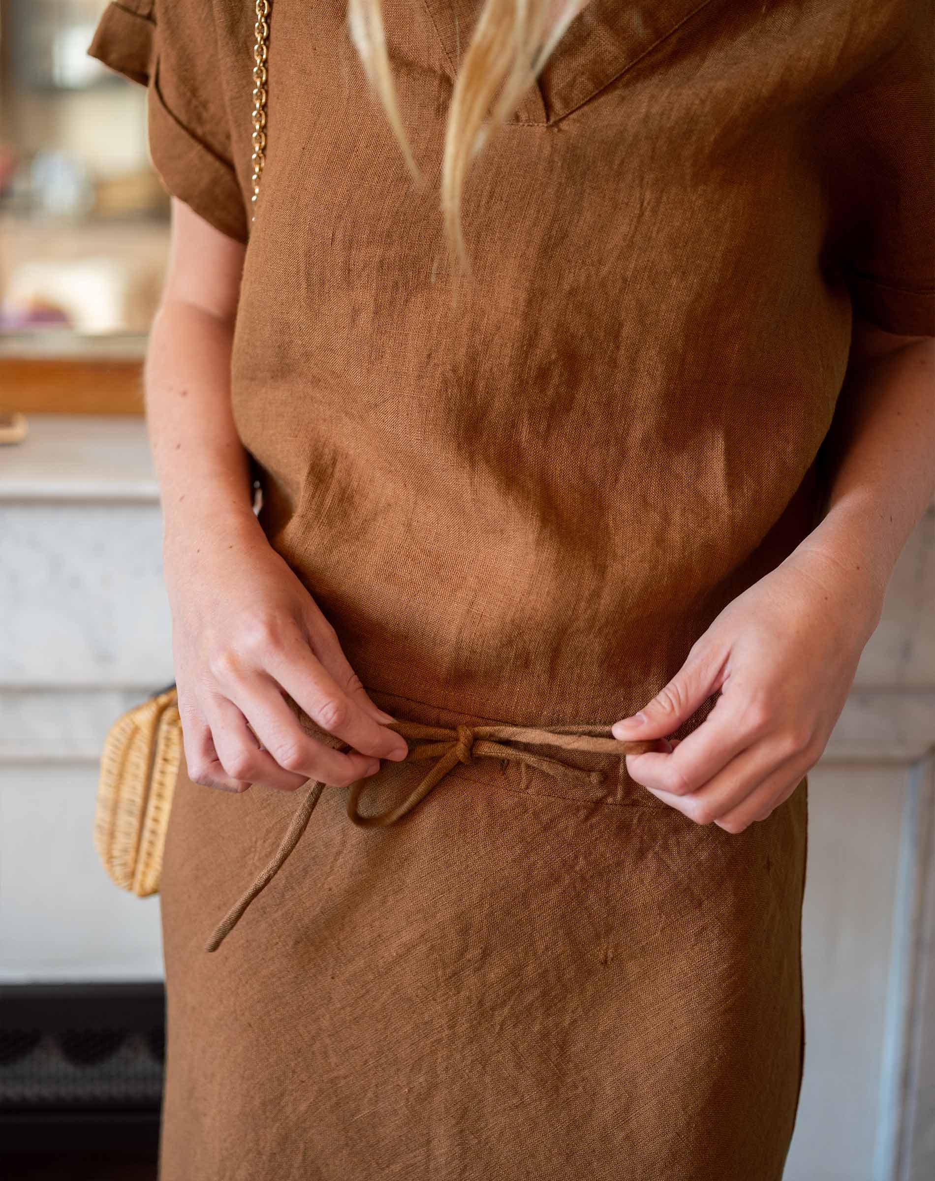 Person wearing a brown dress with a blurred background
