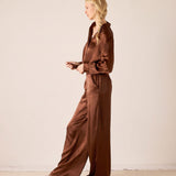 Chocolate brown silk button-up jumpsuit.