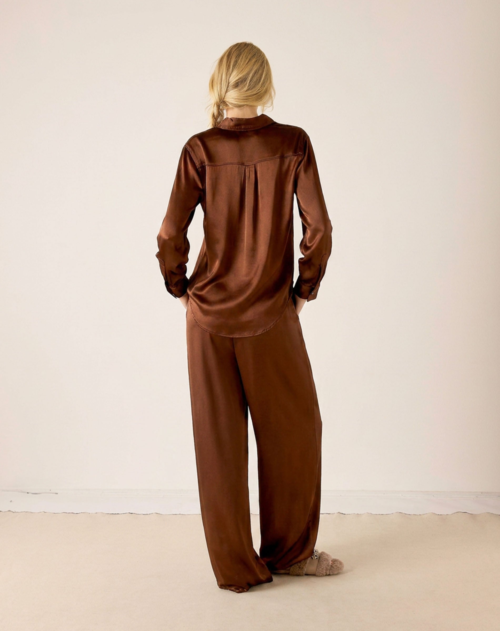 Back view of the chocolate brown Alcott button-up satin shirt and matching wide-leg pants.