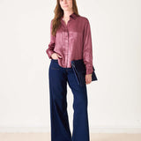 Women's travel-friendly mauve and gold button-up shirt in a textured fabric.