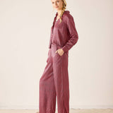 Dusty rose ribbed knit button-up shirt and matching wide-leg trousers.