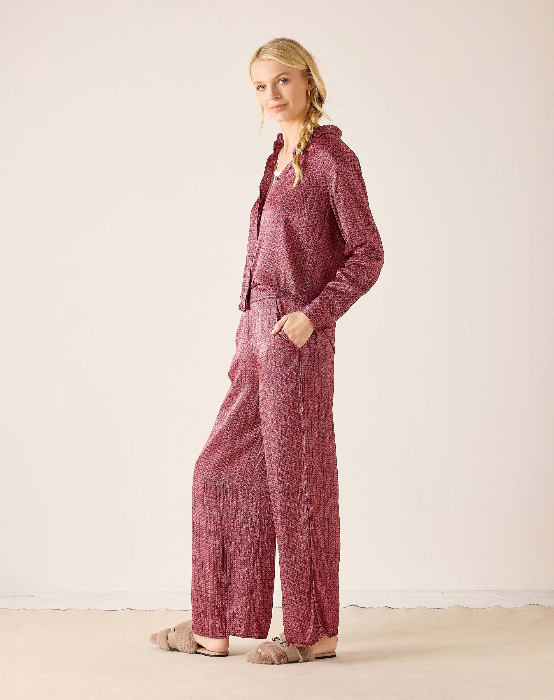 Dusty rose ribbed knit button-up shirt and matching wide-leg trousers.