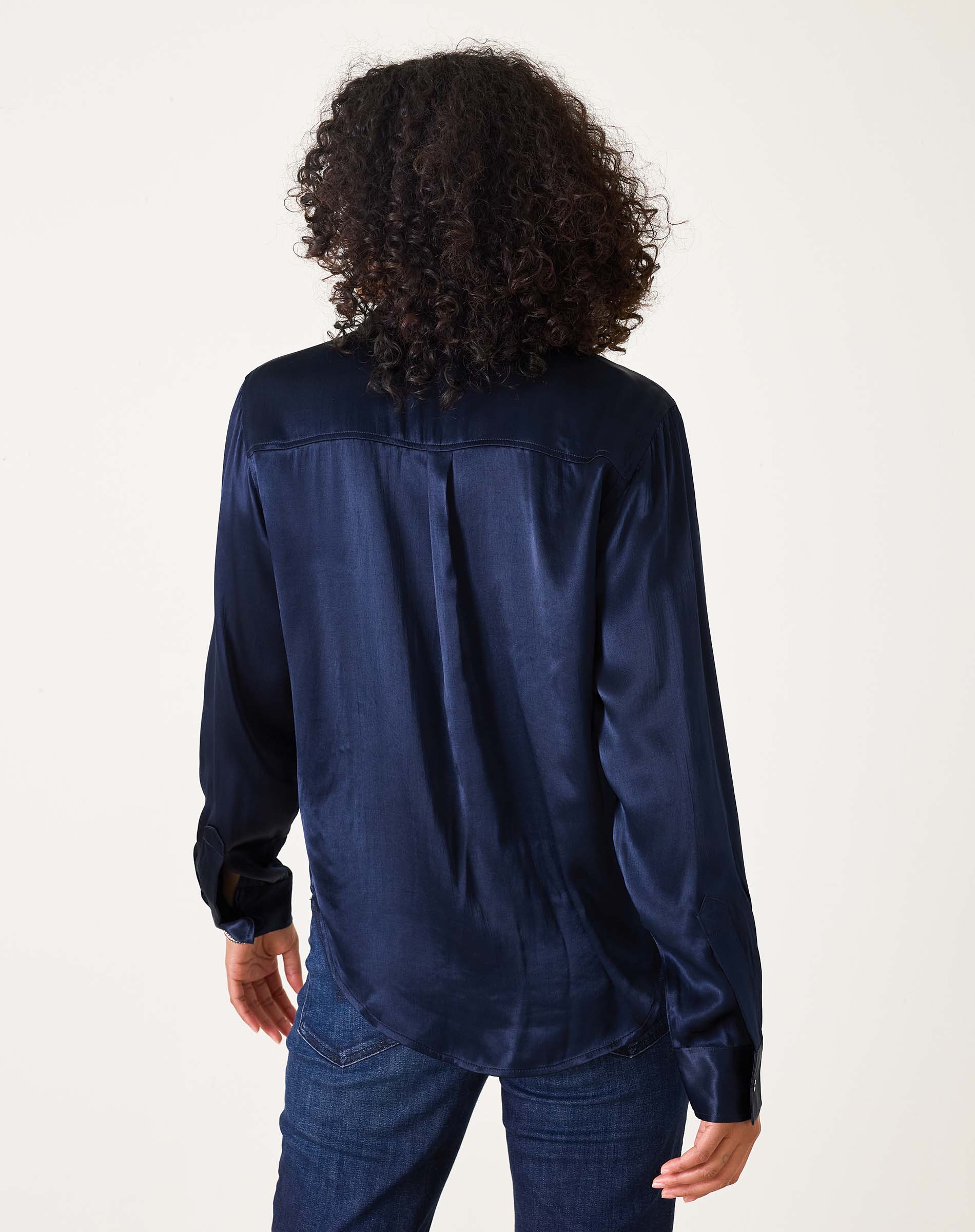 Back view of women's travel-friendly navy button-up shirt in a smooth satin-finish fabric.