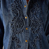 Bleu embroidered chambray button-down shirt with intricate floral embroidery and gold-toned buttons.