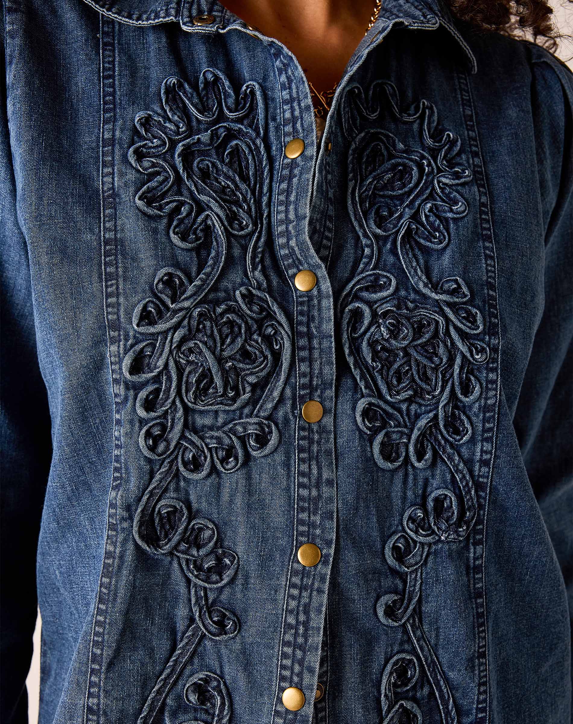 Bleu embroidered chambray button-down shirt with intricate floral embroidery and gold-toned buttons.