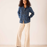 Bleu embroidered chambray button-down shirt with intricate eyelet-style stitching and long sleeves.