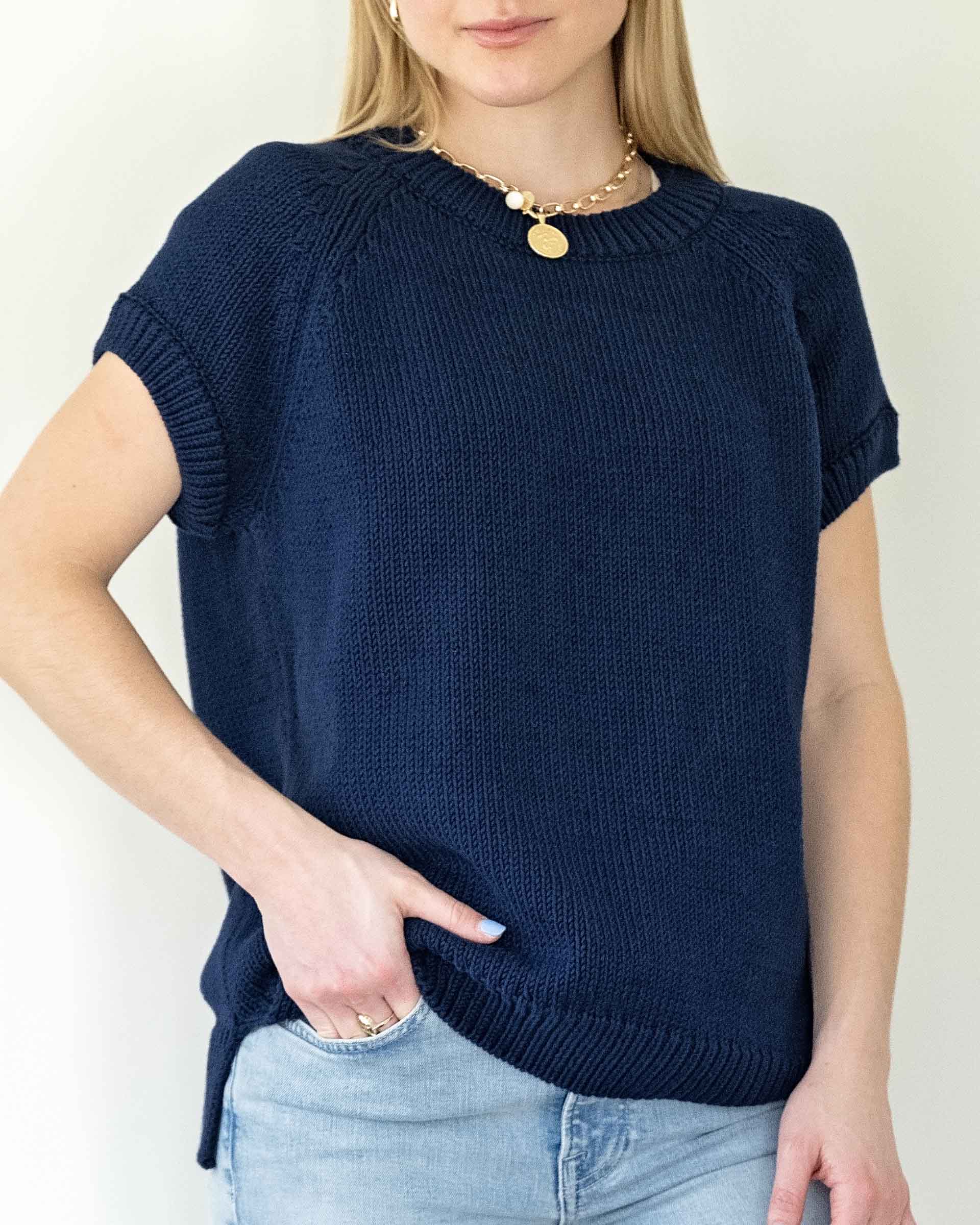 woman wearing navy short sleeve sweater chest view