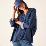 Navy chambray tee with rolled sleeves and relaxed fit.