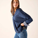Navy chambray tee with rolled sleeves and a relaxed fit.