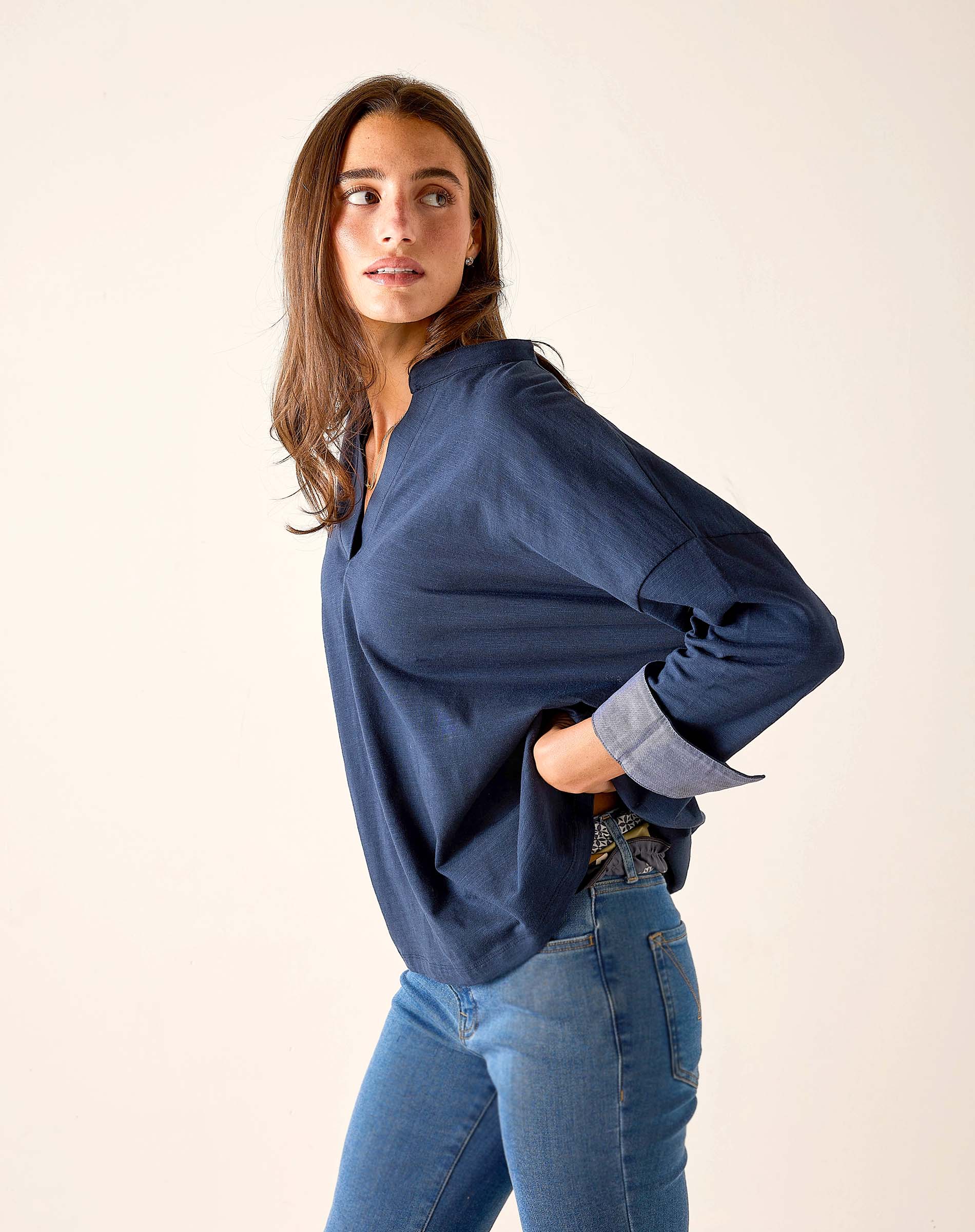 Navy chambray tee with rolled sleeves and a relaxed fit.