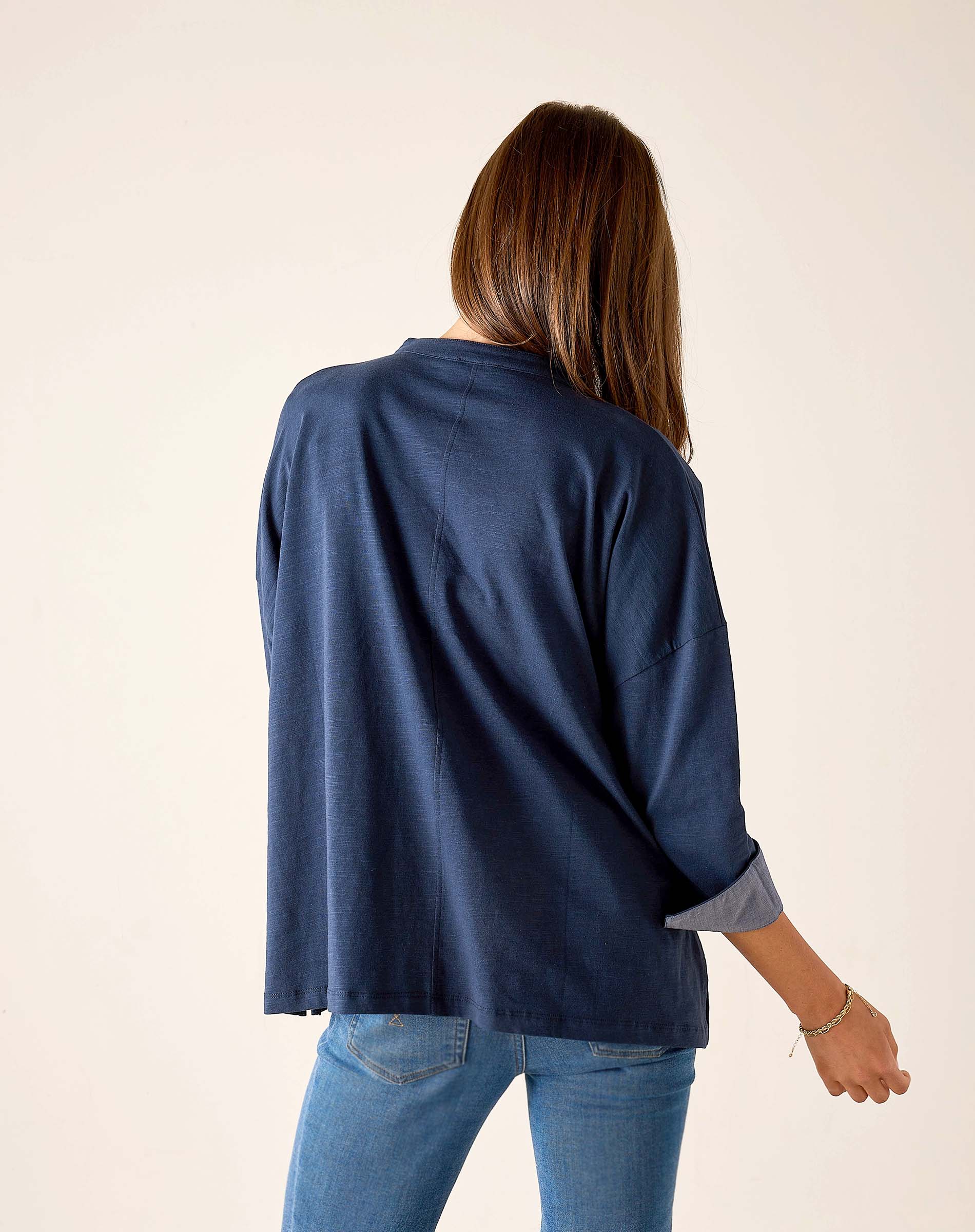 Back view of the navy chambray tee with short sleeves and a contrast cuff.