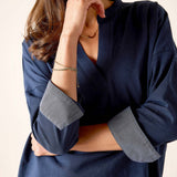 Navy chambray tee with large folded cuffs and a relaxed fit.
